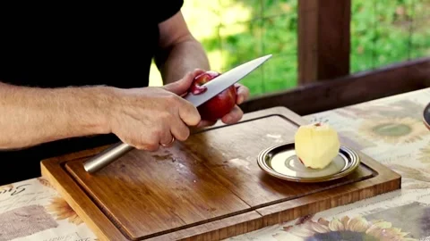 Hand peeling apple, focus on hands, 120fps Stock Footage 132433715