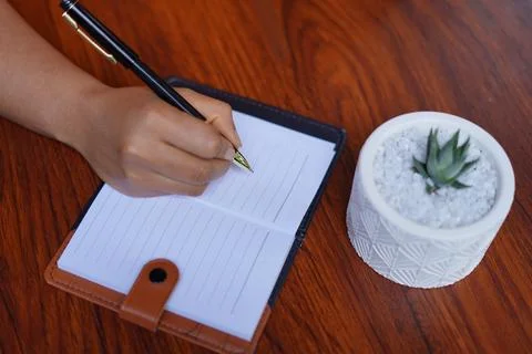 Hand with pen and notebook. image 스톡 사진