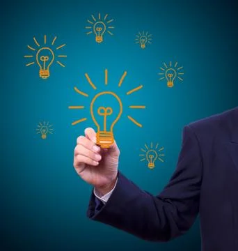 Hand with pen drawing light bulb Stock Photos