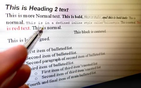 Hand with pen indicate text formatting rules on word processor software on Stock Photos