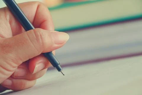 Hand with pen Stock Photos