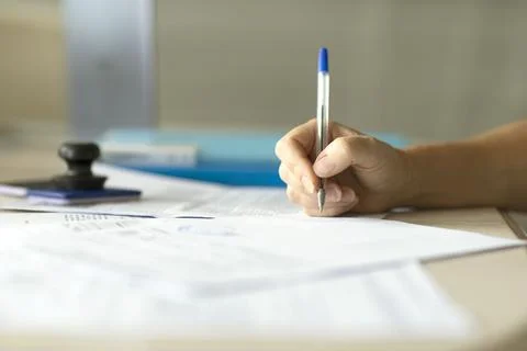 Hand with pen signing the document Stock Photos