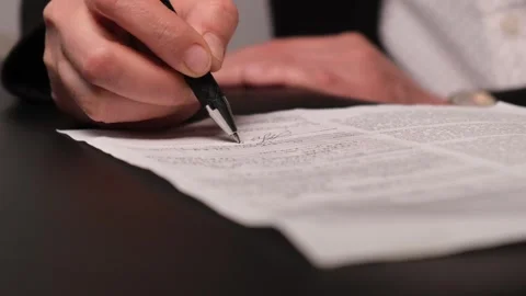 Hand with pen signing documents or contracts Stock Footage 310627223