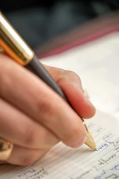 Hand with pen when signing document. Stock Photos