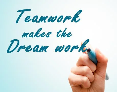 Hand with pen writing team work makes the dream work Stock Photos