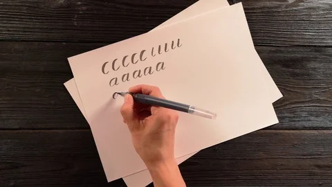 Hand with penbrush does lettering exercise Stock Footage 96218949