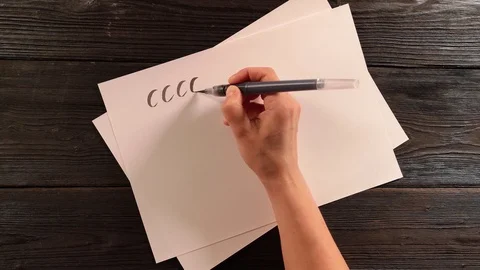 Hand with penbrush does lettering exercise Stock Footage
