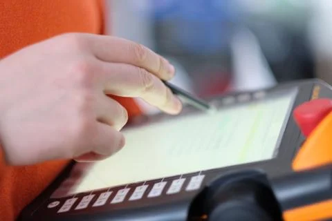 Hand with a pencil over an electronic. control panel for special equipment Stock Photos