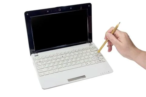 Hand with pencil pushing enter button on laptop Stock Photos