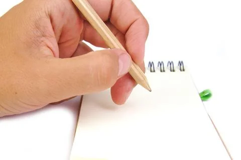Hand with pencil take notes in a notebook on white background Stock Photos