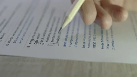 Hand with a pencil ticks checkbox marks filling up to do list. Stock Footage 169705493