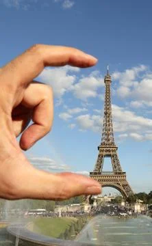 Hand performing the measurement of the Eiffel Tower in Paris in France Stock Photos
