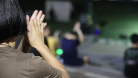 The hand of the person clapping while watching the performance at night Stock Footage 284628871