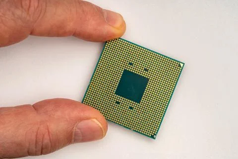 Hand of a person holding a computer processor close-up. CPU. Stock Photos