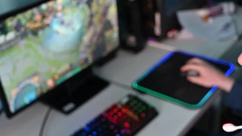 Hand of a person playing computer game using an LED mouse pad Stock Footage 127597668