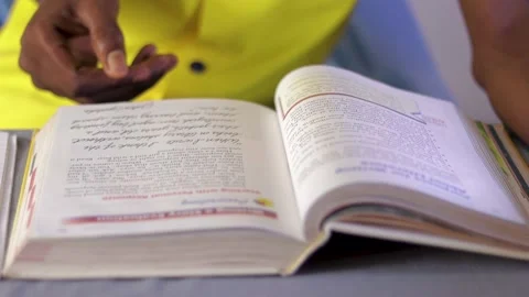 Hand of a person pointing to texts while reading. Reading a book.	 Stock Footage 201316738