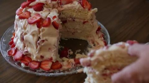 Hand of a person taking a slice of freshly baked strawberry cake Stock Footage 150651630