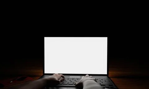 The hand of a person using a notebook or laptop, a blank screen, white, dar.. Foto stock