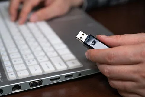 The hand of a person using a USB memory. Cyber Information Protection Concept Stock Photos