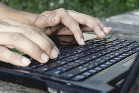 Hand Person working and using on a laptop computer for freelance with input.. Stock Photos