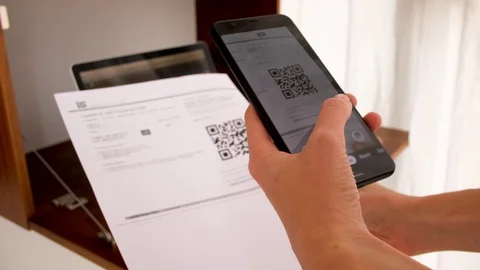 Hand with phone scans QR Code Video stock 128419454