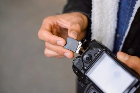 Hand of photographer holding SD memory Card Stock Photos