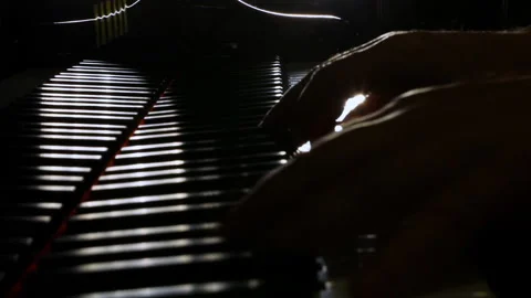 Hand on piano. Backlight. Stock Footage 134576860