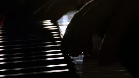 Hand on piano. Backlight. Stock Footage 134577885