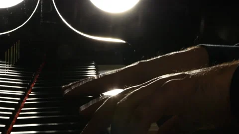 Hand on piano. Backlight. Video stock 134577943