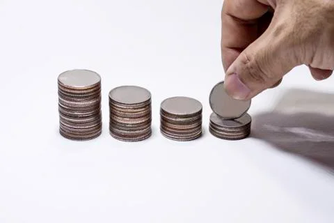 Hand pick up coin to collect in stack, Saving money concept, Man hand to hold Stock Photos