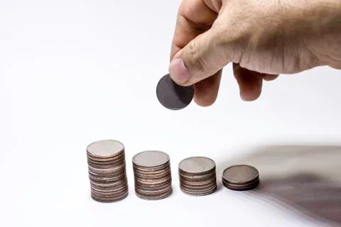 Hand pick up coin to collect in stack, Saving money concept, Man hand to hold Stock Photos