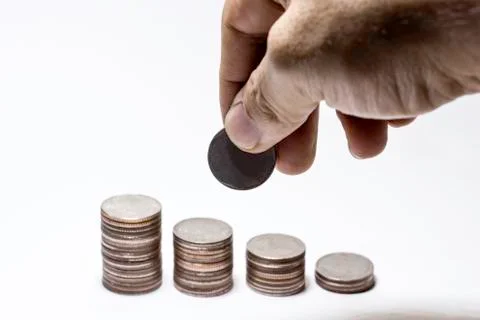 Hand pick up coin to collect in stack, Saving money concept, Man hand to hold Stock Photos
