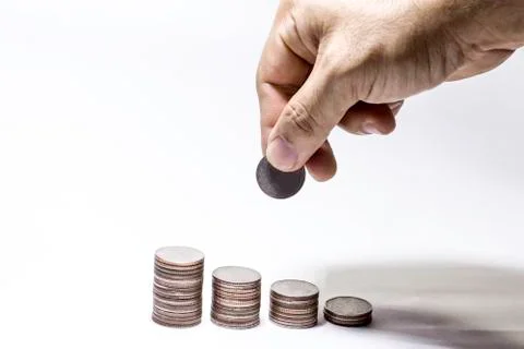 Hand pick up coin to collect in stack, Saving money concept, Man hand to hold Stock Photos