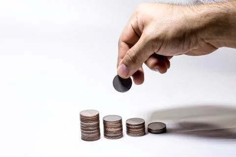 Hand pick up coin to collect in stack, Saving money concept, Man hand to hold Foto stock