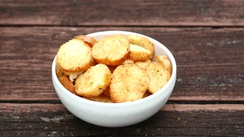 Hand pick garlic bread on a plate on table 스톡 동영상 216875822