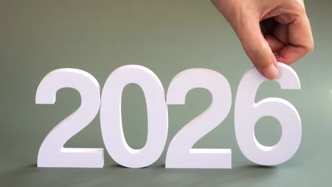 Hand pick up the number 5 and place the number 6 changing to year 2026 Stock Footage 321860993