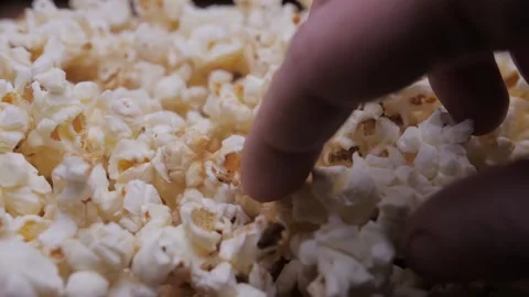 Hand pick up popcorn Stock Footage 150458108