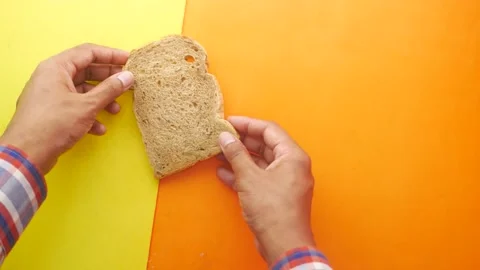 Hand pick slice of brown bread from a table 스톡 동영상 155920566