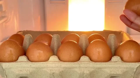 Hand picked up an egg in paper shelf from  the refrigerator with warm light Stock Footage 197495368