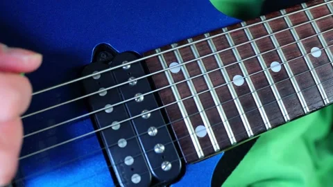 Hand picking a 7-string electric blue guitar at a high shutter speed 動画素材 223050298