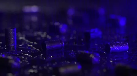 Hand picking up 9 mm bullet casings on the ground with flashing lights Stock Footage 21766436