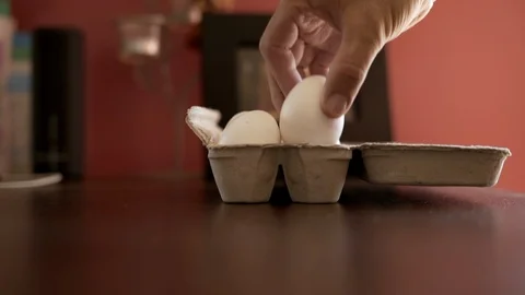 Hand picking and breaking an egg for breakfast. 60fps Video stock 91028450