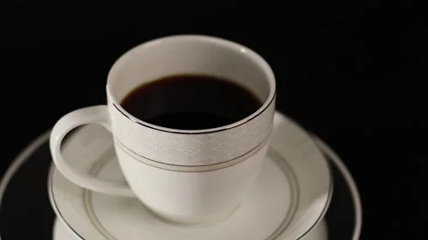 Hand picking up a black coffee cup Placed on a rotating stand Stock Footage 250074699