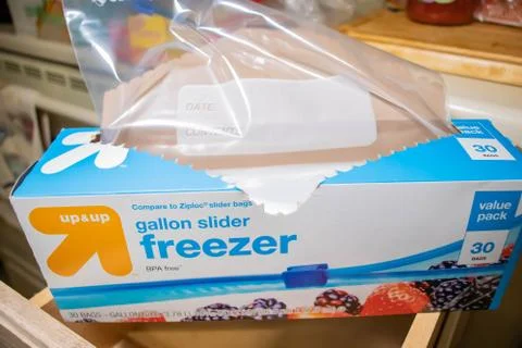 Hand picking up a box of zip lock bags Foto stock