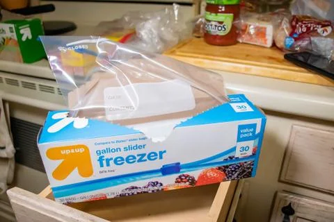 Hand picking up a box of zip lock bags 스톡 사진