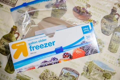Hand picking up a box of zip lock bags Stock Photos