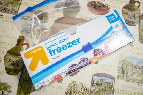 Hand picking up a box of zip lock bags Stock Photos
