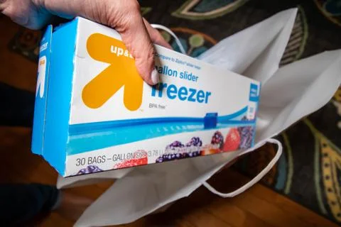 Hand picking up a box of zip lock bags Stock Photos