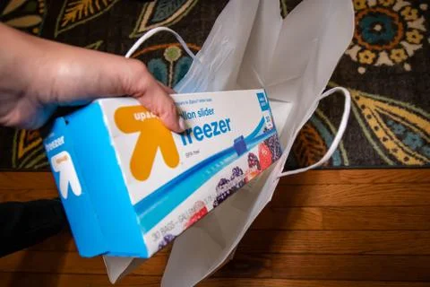 Hand picking up a box of zip lock bags Foto stock