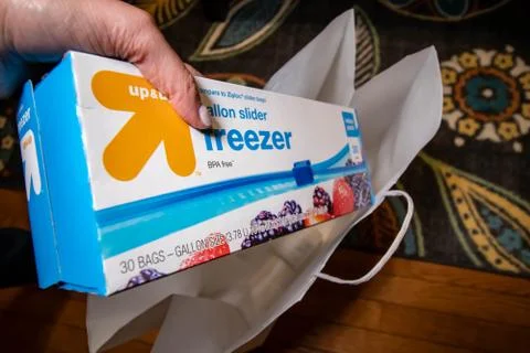 Hand picking up a box of zip lock bags Stock Photos